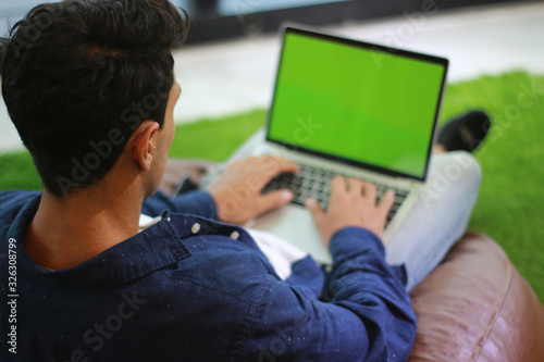 Fototapeta Naklejka Na Ścianę i Meble -  working at home with laptop man writing a chat massage