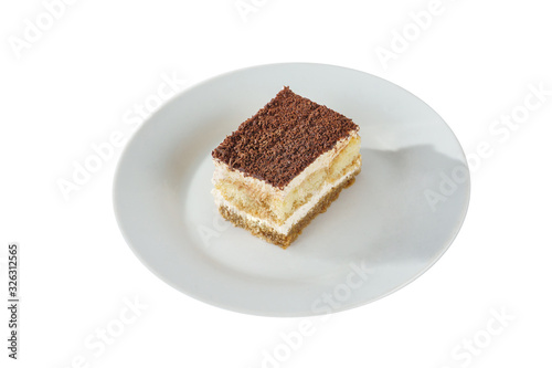 Rectangular piece of Tiramisu on a white plate, isolated on white background. Dessert for a menu in a cafe, restaurant, coffee shop side view