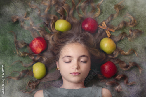 Image of a beautiful girl with apples in her hair