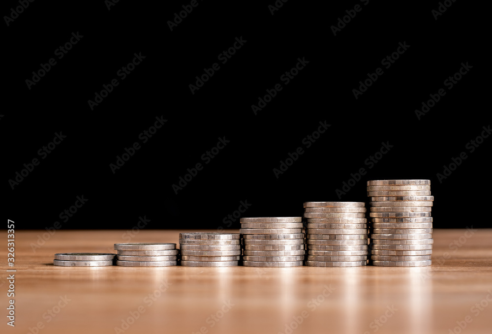 Business concept of Stack coins for saving money on investment with black background Business concept of Stack coins for saving money on investment with black background