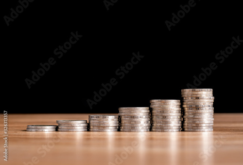 Business concept of Stack coins for saving money on investment with black background