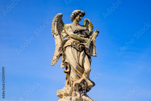 Statue of angel on Ponte Sant Angelo  a Roman bridge in Rome  Italy