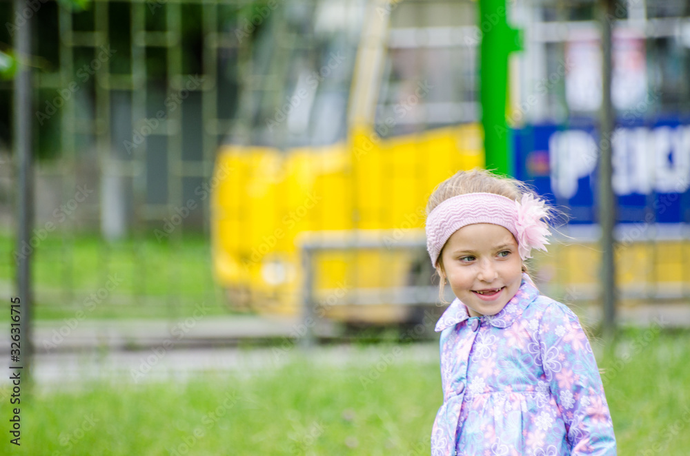 5 years old cute little girl playing in sunny summer park.Happy kid girl walking and jumping in a forest.Kids play outdoors.Kindergarten in school yard on summer day. 5 years old cute little girl playing in sunny summer park.Happy kid girl walking and jumping in a forest.Kids play outdoors.Kindergarten in school yard on summer day.