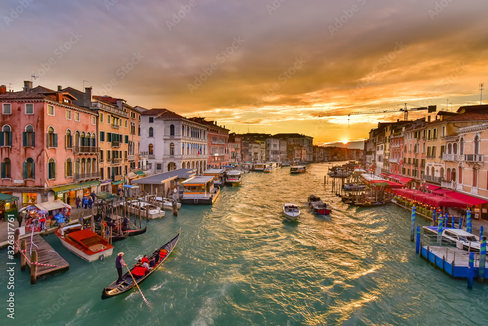 The Grand Canal with gondola and vaporetto at sunset time, Venice, Italy