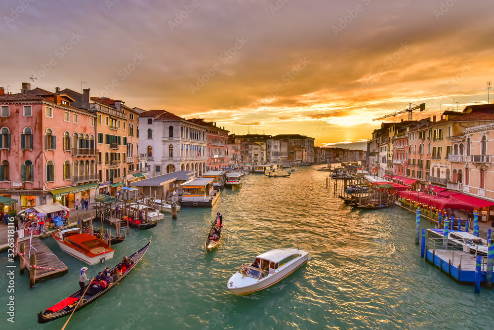 The Grand Canal with gondola and vaporetto at sunset time, Venice, Italy