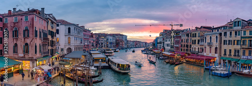 The Grand Canal with gondola and vaporetto at sunset time, Venice, Italy © momo11353