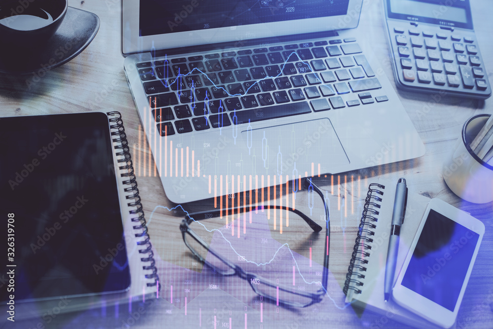 Forex market chart hologram and personal computer background. Double exposure. Concept of investment. Forex market chart hologram and personal computer background. Double exposure. Concept of investment.