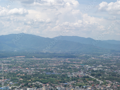 Looking out at window airplane see landscape city view of Chiang Rai, Thailand. Top view of beautiful mountains, forest, trees, river, road and cityscape. Holiday and Travel concept