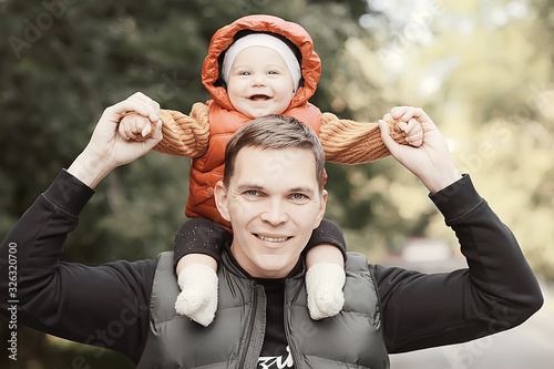 baby dad on his shoulders / family care fatherhood, dad and son, family happiness walk