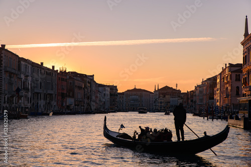 Silhouette of gondola on the Grand Canal at sunrise / sunset time, Venice, Italy