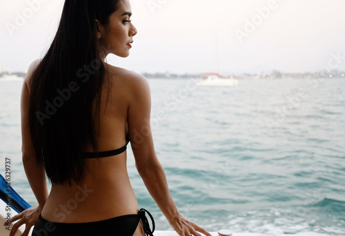 Beautiful Asia young woman sexy bikini traveling on boat in holiday weekend at Thailand. © Watercolor_Concept