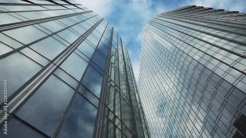 California, USA. 04. January. 2020. Time lapse of clouds reflecting onto the glass of a large office building. Reflection of clouds in a modern skyscraper. California, USA. 04. January. 2020. Time lapse of clouds reflecting onto the glass of a large office building. Reflection of clouds in a modern skyscraper.