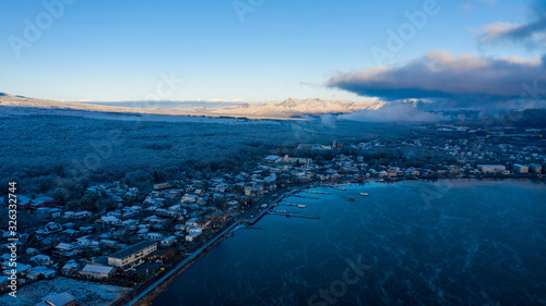 Aerial view of lake Yamanaka near Mount Fuji, winter scenery with freezing fog on trees during sunrise - landscape panorama of Japan from above, Asia