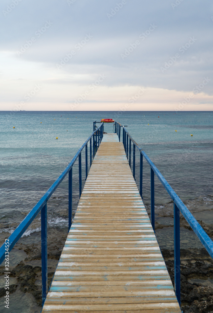 Old wooden pier leading to the sea on Cyprus.