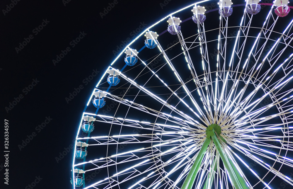 Colorful ferris wheel in the city park at night. Colorful ferris wheel in the city park at night.
