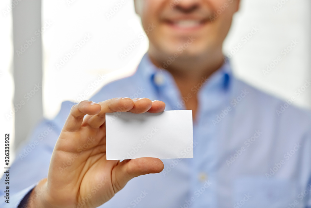 business and people concept - close up of smiling man holding empty white card business and people concept - close up of smiling man holding empty white card
