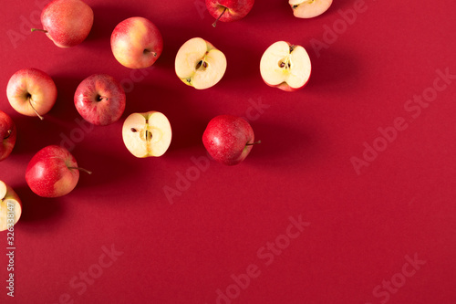 Red apples on red background. Apples as background. Flat lay, top view, copy space