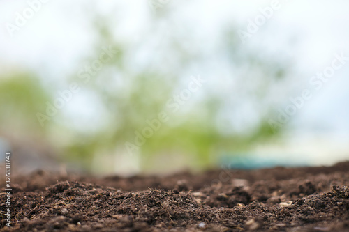Spring natural soil background for planting plants. Beautiful bokeh. Copy space.