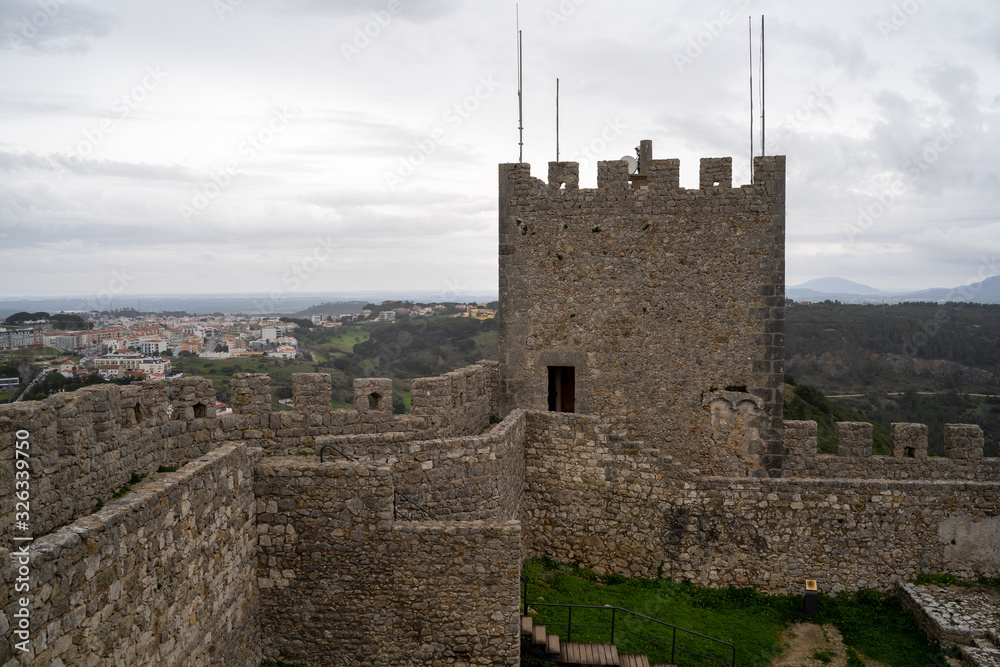 View of the interior ruins of Sesimbra Castle on an overcast winter day