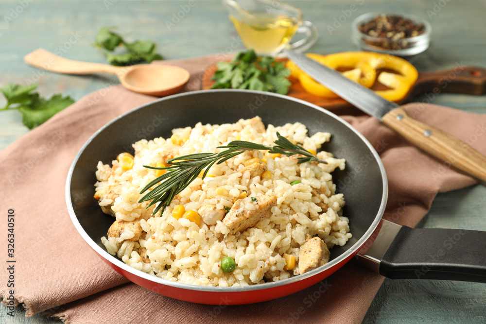 Delicious chicken risotto on light blue wooden table Delicious chicken risotto on light blue wooden table