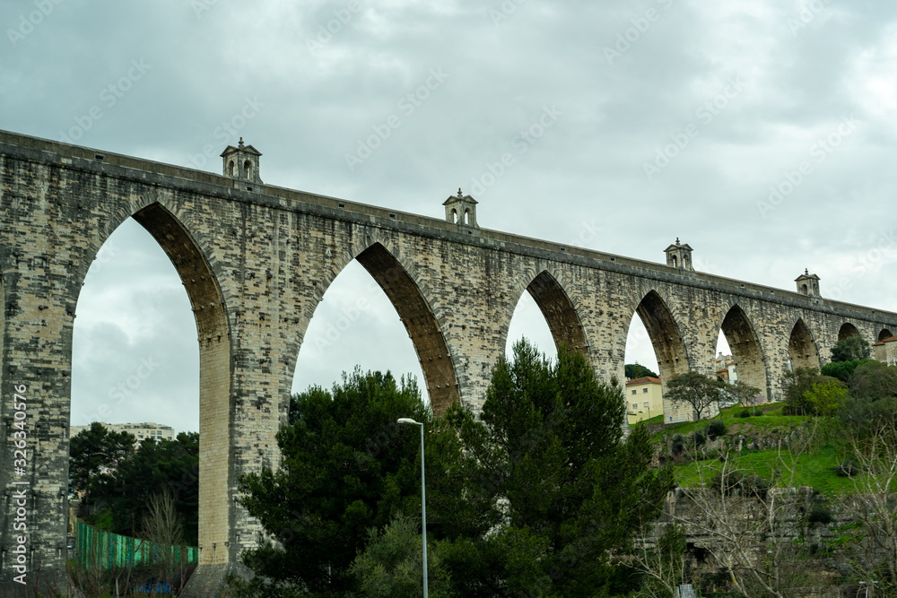 Lisbon, Portugal -  Águas Livres Aqueduct (Portuguese translation: Aqueduto das Águas Livres), a historic aqueduct from the 18th Century, as seen from the highway