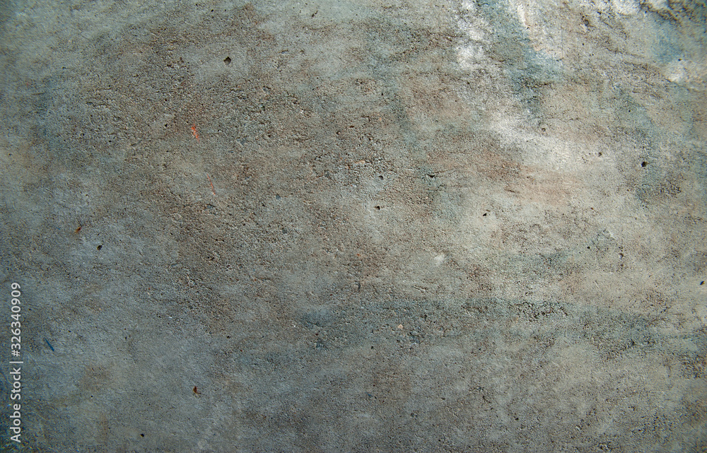 Abstract background. An old concrete wall with patches of various shades of gray and light blue. Structure, background. Abstract background. An old concrete wall with patches of various shades of gray and light blue. Structure, background.