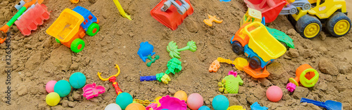 Naklejka lot of children's toys in the sandbox. Selective focus.