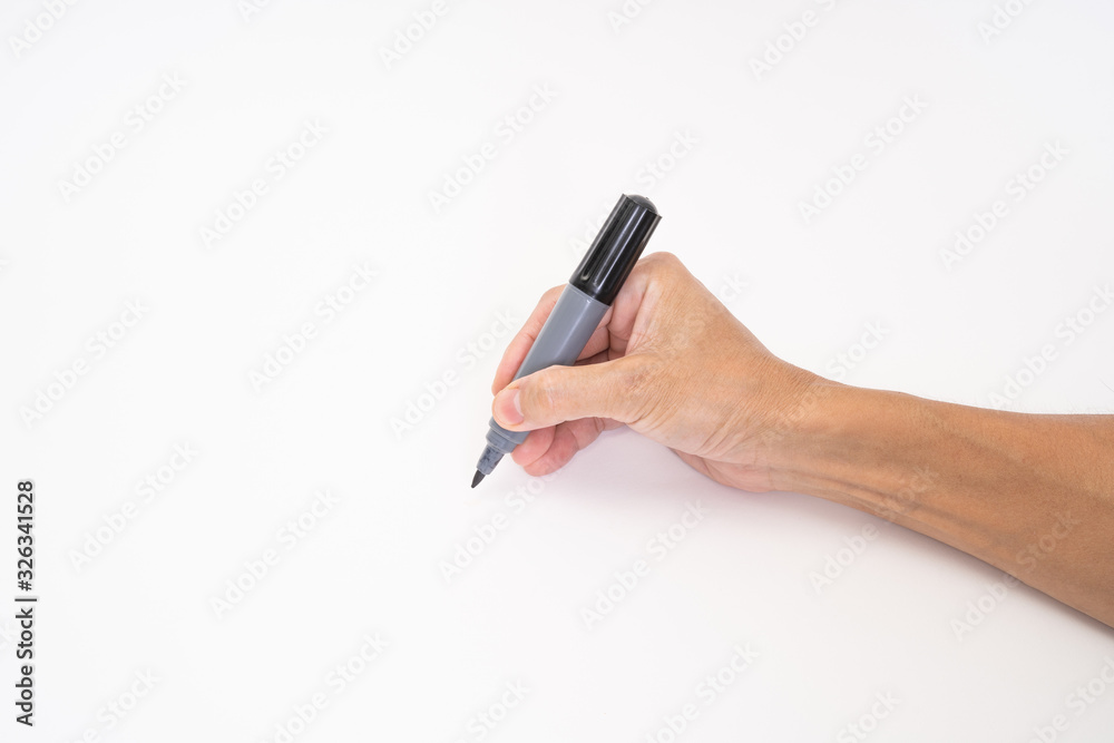 Man hand holding black magic marker pen writing on white background Man hand holding black magic marker pen writing on white background