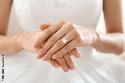 Young bride wearing beautiful engagement ring, closeup