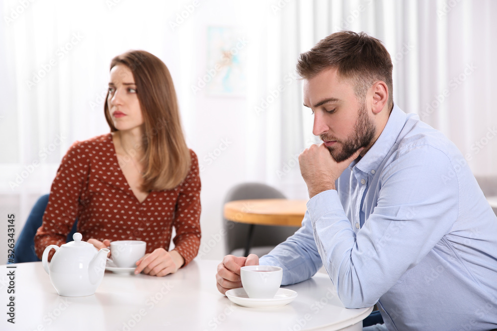Couple with relationship problems at table in cafe Couple with relationship problems at table in cafe