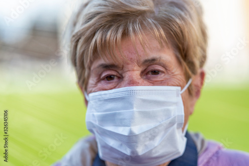 Coronavirus alarm in Italy, Europe. Woman wearing mouth mask visiting city