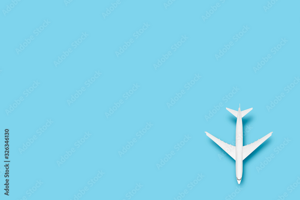 Toy airplane on a blue background. Concept travel, airline tickets, flight. Flat lay, top view Toy airplane on a blue background. Concept travel, airline tickets, flight. Flat lay, top view
