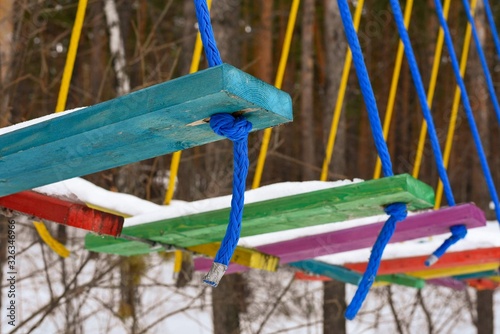 Multi-colored wooden steps in a rope park photo