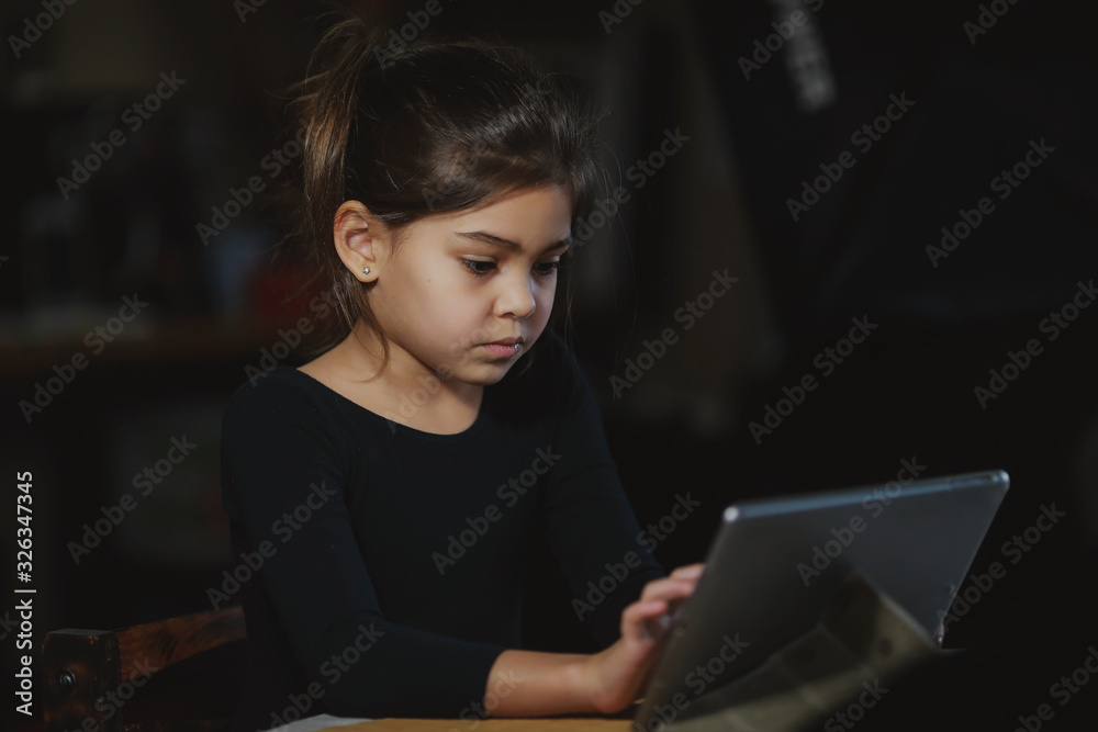 girl playing on a tablet girl playing on a tablet