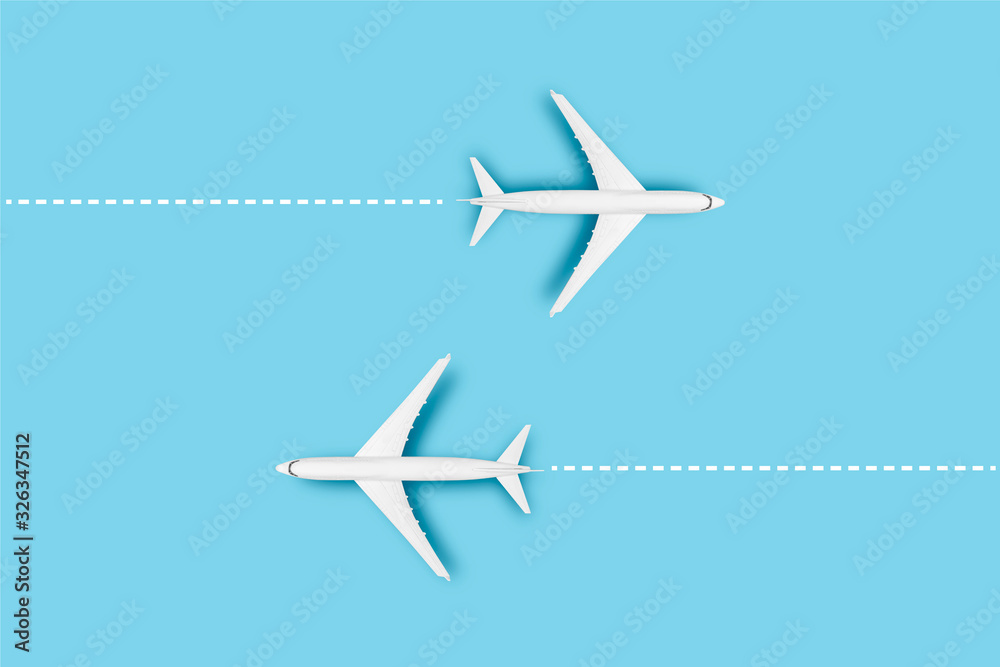 Naklejka premium Two Airplanes and a line indicating the route on a blue background. Concept travel, airline tickets, flight, route pallet. Banner. Flat lay, top view
