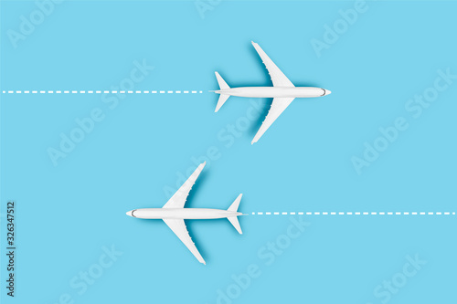Two Airplanes and a line indicating the route on a blue background. Concept travel, airline tickets, flight, route pallet. Banner. Flat lay, top view