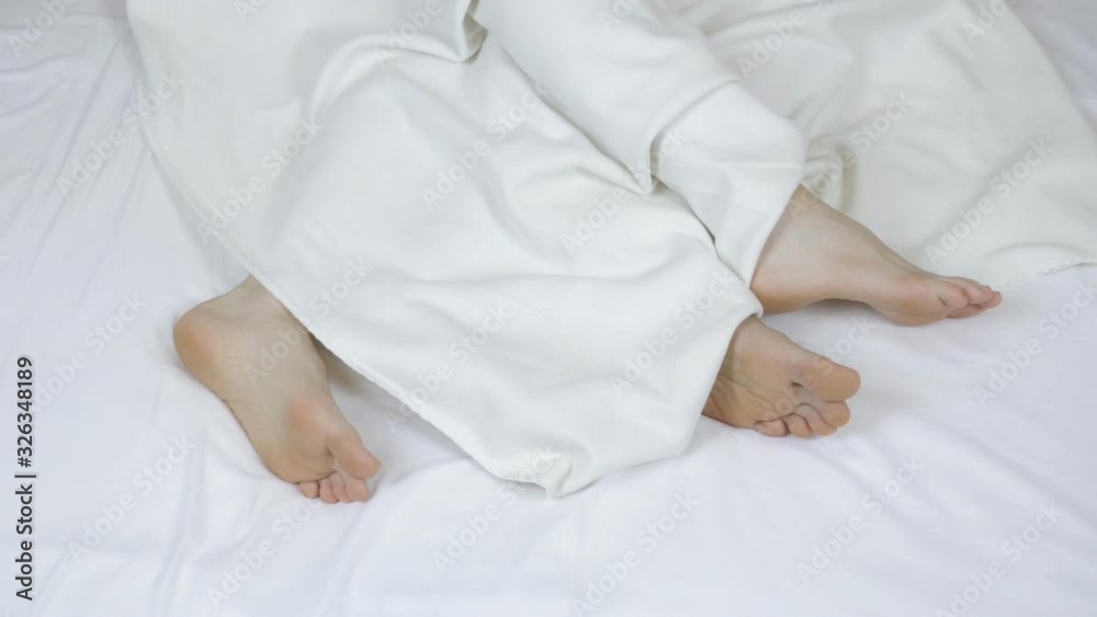 Couple in bed making love. Male and female legs on a snow-white bed. view from above. Sex, 4K Couple in bed making love. Male and female legs on a snow-white bed. view from above. Sex, 4K