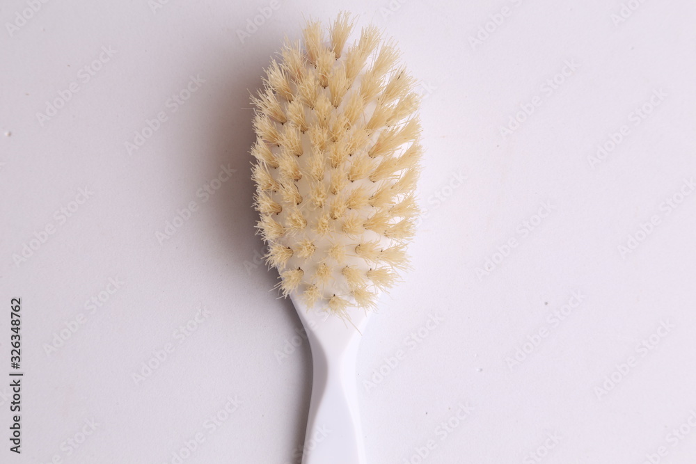 Naklejka premium white hairbrush in color background