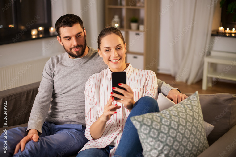 technology and people concept - happy couple with smartphone taking selfie in bed at home technology and people concept - happy couple with smartphone taking selfie in bed at home