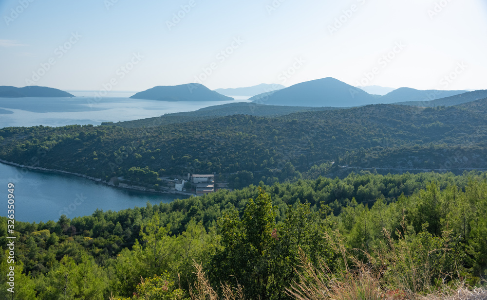 View of the sea coast with islands and houses scattered in the mountains. Croatia.