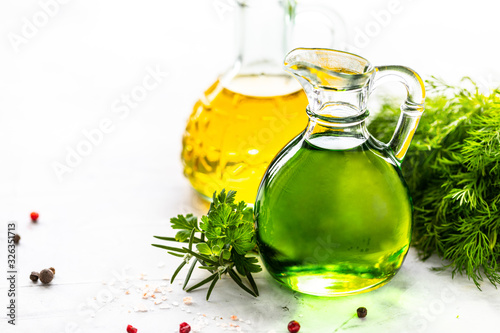 Different types of vegetable oil in glass bottles: sesame, linseed, grape oil. Place for text