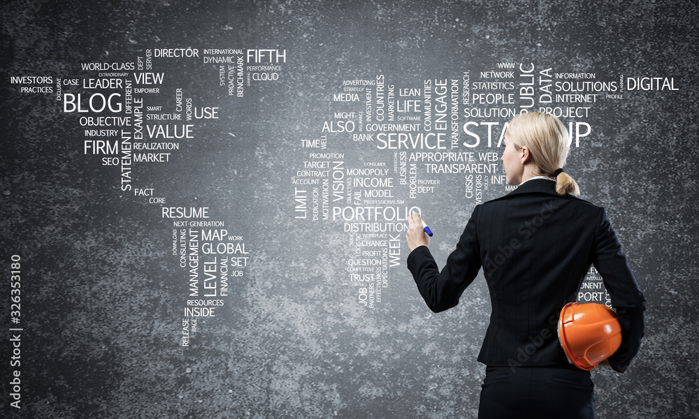 Businesswoman standing near world map on wall Businesswoman standing near world map on wall