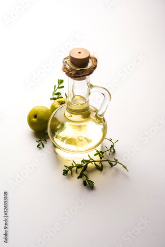 Brahmi Amla Ayurvedic Hair Oil with raw avla and Bramhi leaves photo