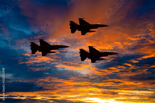 Fototapeta Naklejka Na Ścianę i Meble -  Silhouette army Show performant of air craft in air show with sun sky ocean view at sunset time background.