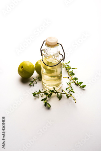 Brahmi Amla Ayurvedic Hair Oil with raw avla and Bramhi leaves photo