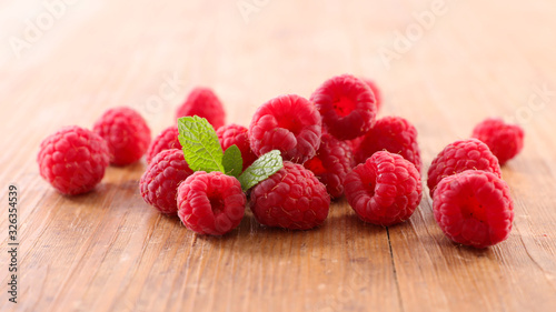 raspberry- berry fruit and mint on wood background