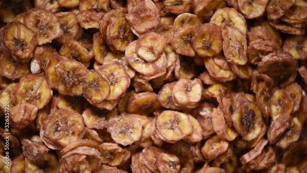 Dried banana on rotating background. Dried fruits background. Vegan, vegetarian diet. Healthy lifestyle. Fresh sweet bananas texture, organic food. Food ingredient background. Dried banana on rotating background. Dried fruits background. Vegan, vegetarian diet. Healthy lifestyle. Fresh sweet bananas texture, organic food. Food ingredient background.
