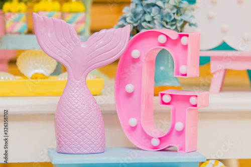 Mermaid tail party decoration with a letter G on the side photo