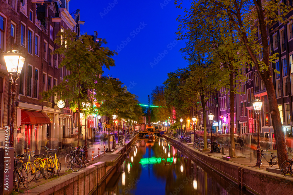Night view of De Wallen, the famous red-light district with window prostitution in Amsterdam, Netherlands