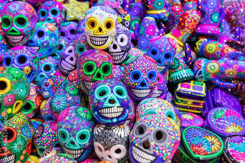 Decorated colorful skulls, ceramics death symbol at market, day of dead, Mexico.